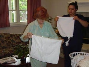 Folding laundry with resident and staff at Dolan 