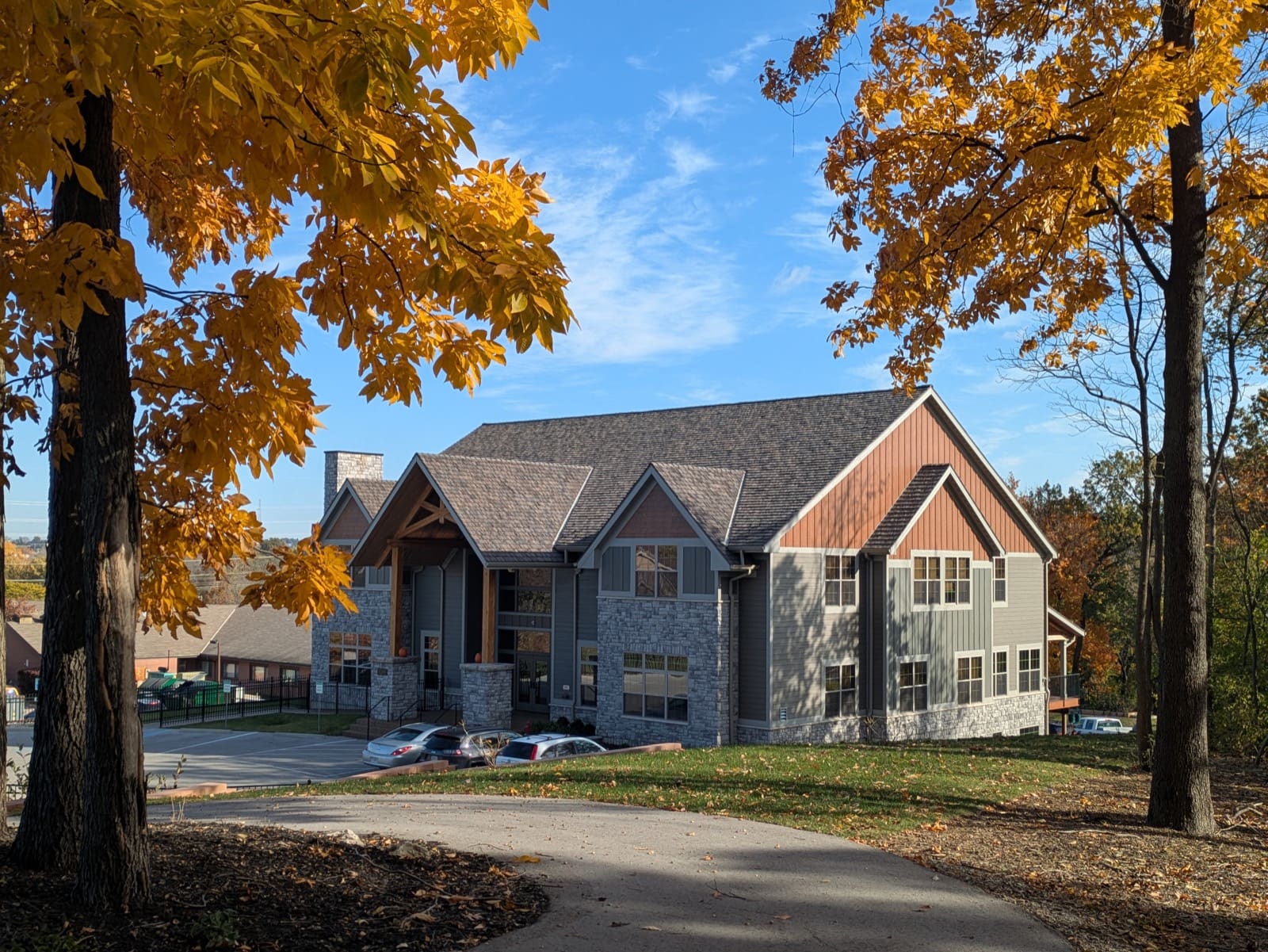 Exterior of a Dolan memory care home on a residential street in autumn