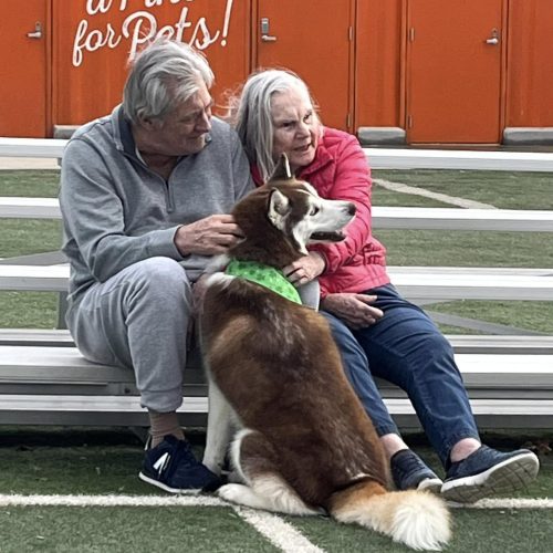 Two Dolan residents petting a furry dog