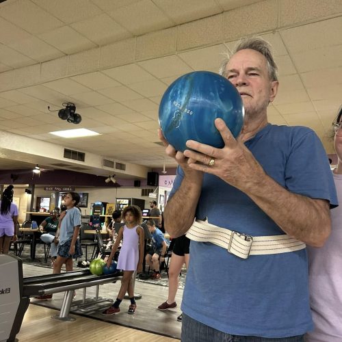 Resident at Dolan holding blue bowling ball